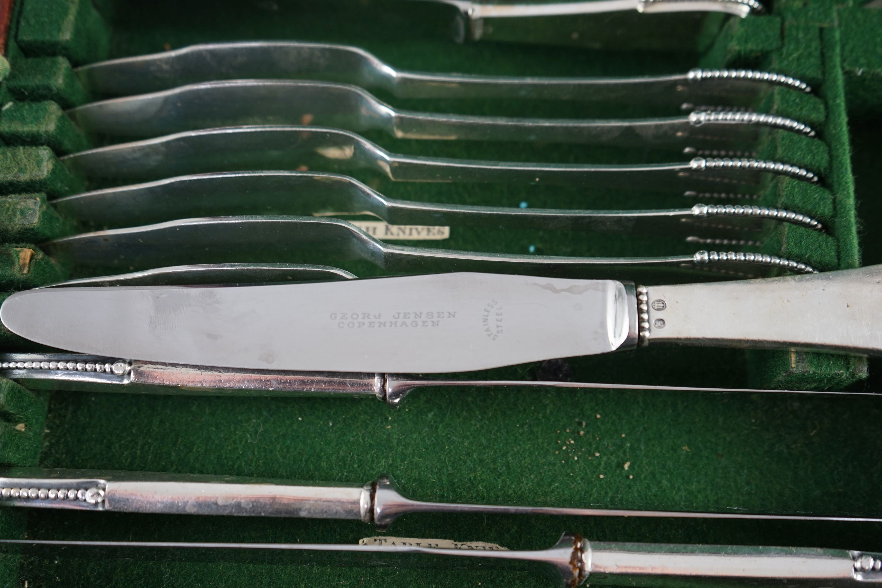 An early 20th century Georg Jensen canteen of beaded pattern silver cutlery